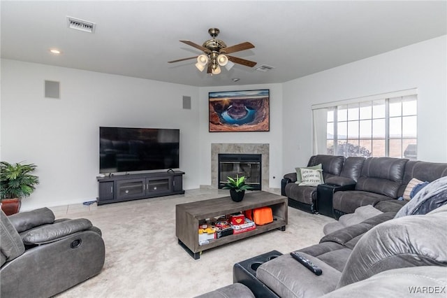 living room with a ceiling fan, carpet, and visible vents