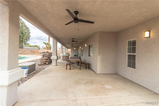 view of patio with a fenced in pool, ceiling fan, and fence