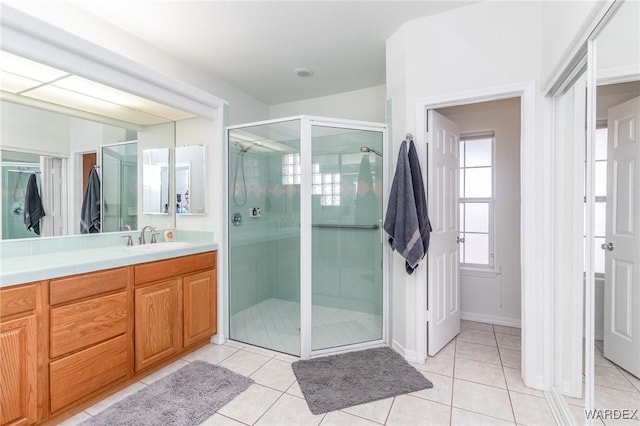 bathroom with vanity, a shower stall, and tile patterned flooring