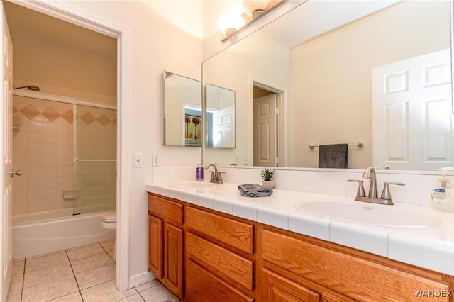 full bathroom with tile patterned flooring, double vanity, toilet, and a sink