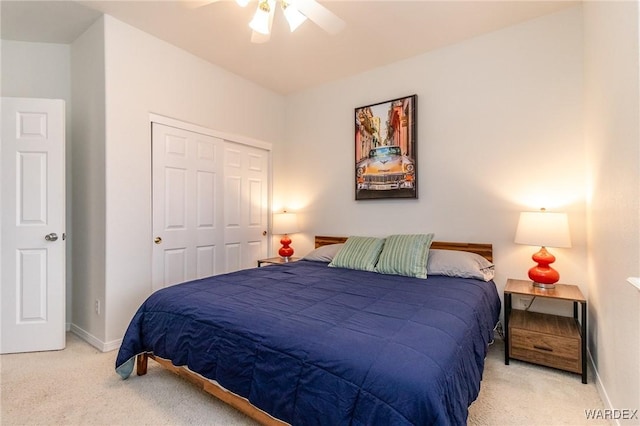 bedroom featuring a closet, ceiling fan, baseboards, and carpet