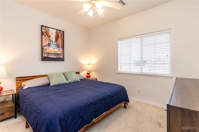 bedroom featuring baseboards, light carpet, and a ceiling fan