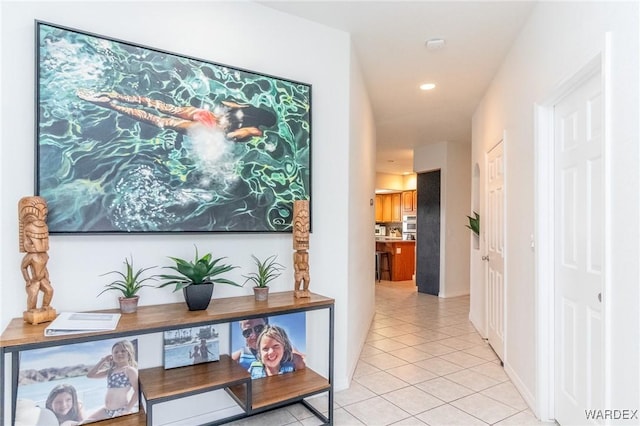 hallway with light tile patterned floors and recessed lighting