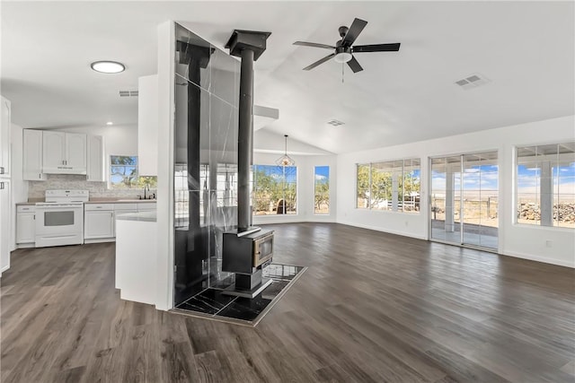 15565 Iron Dr, Dolan Springs, AZ 86441 - living area with a wood stove, ceiling fan, dark wood-style flooring, and high vaulted ceiling