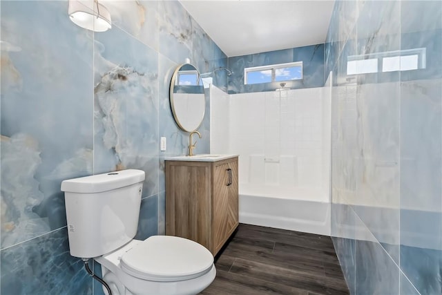 15565 Iron Dr, Dolan Springs, AZ 86441 - bathroom featuring shower / bathtub combination, vanity, tile walls, and wood finished floors