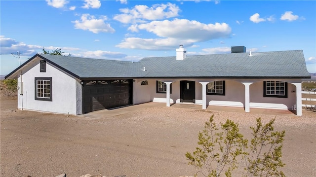 15565 Iron Dr, Dolan Springs, AZ 86441 - single story home with driveway, a porch, a garage, and stucco siding