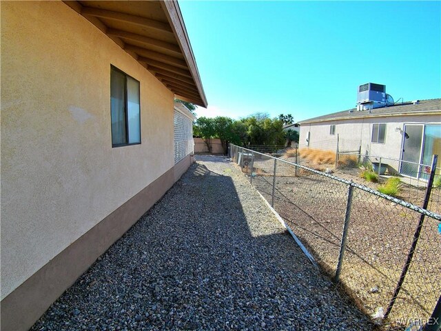 view of yard with a fenced backyard and central air condition unit