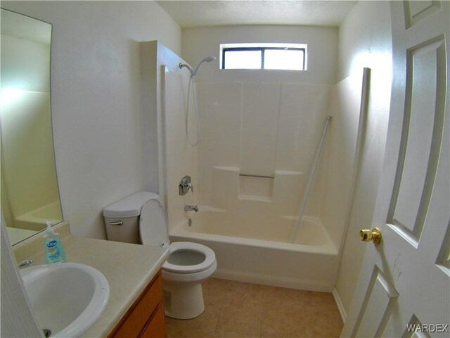 bathroom with washtub / shower combination, vanity, toilet, and tile patterned floors