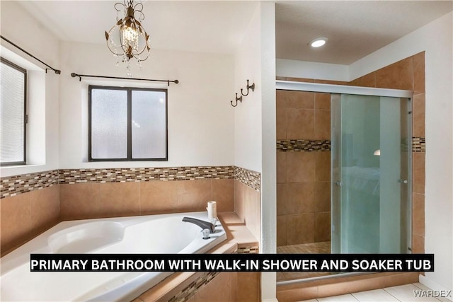 bathroom featuring a garden tub and a shower stall