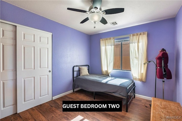 bedroom with visible vents, dark wood finished floors, baseboards, and ceiling fan