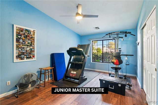 workout area with a ceiling fan, baseboards, visible vents, and dark wood-type flooring