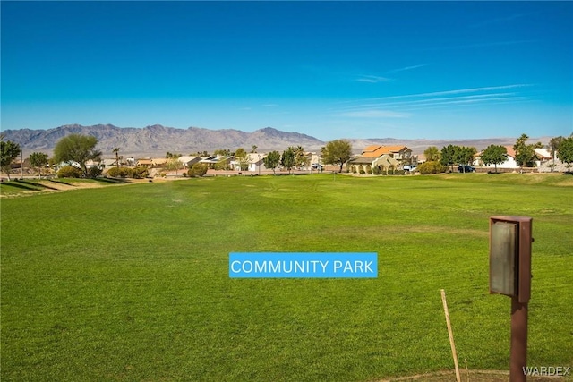 view of community with a yard, a residential view, and a mountain view