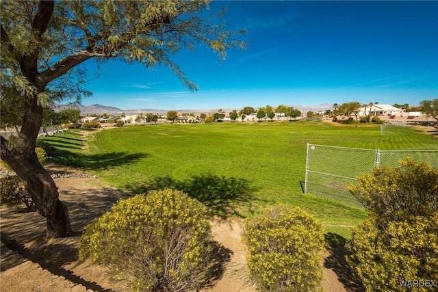 view of community featuring fence and a mountain view