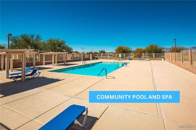 pool featuring fence and a patio