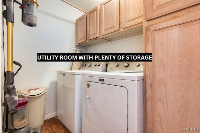 laundry room featuring dark wood-style floors, washing machine and clothes dryer, and cabinet space