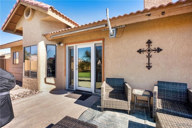 exterior space with a patio area and stucco siding