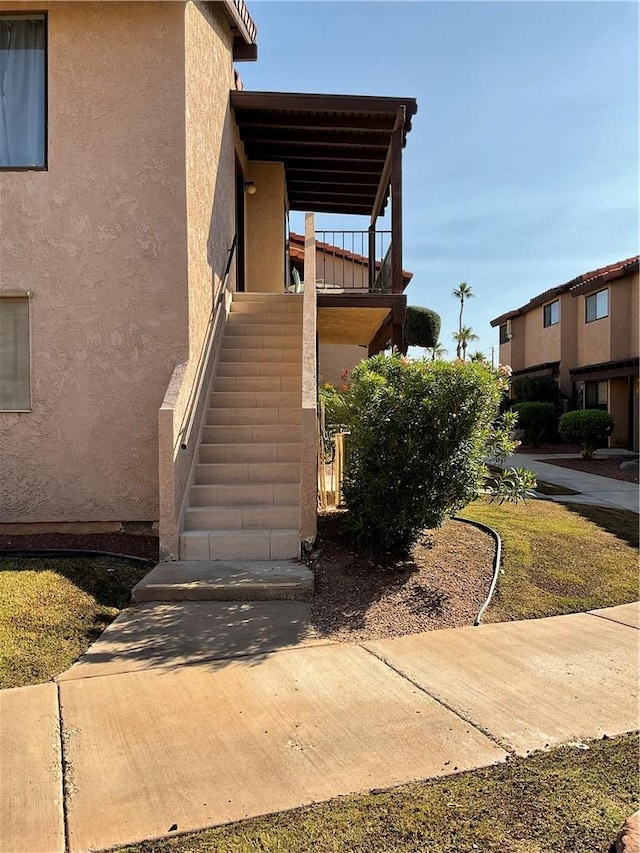 201 Riverfront Drive, Drive, Bullhead City, AZ 86442 - view of side of property featuring stucco siding and stairway