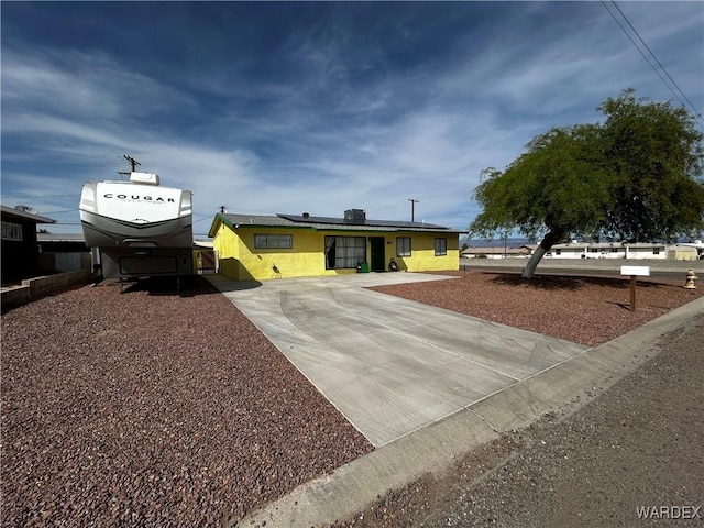 1901 Luna, Ca-Needles, CA 92363 - view of front of house with driveway, solar panels, and stucco siding