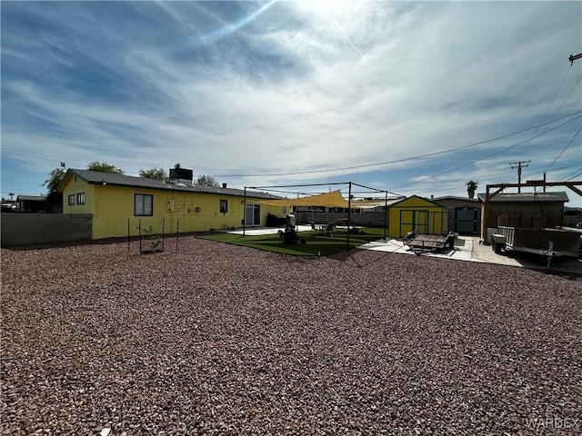 1901 Luna, Ca-Needles, CA 92363 - view of yard featuring a shed, a patio area, an outdoor structure, and fence