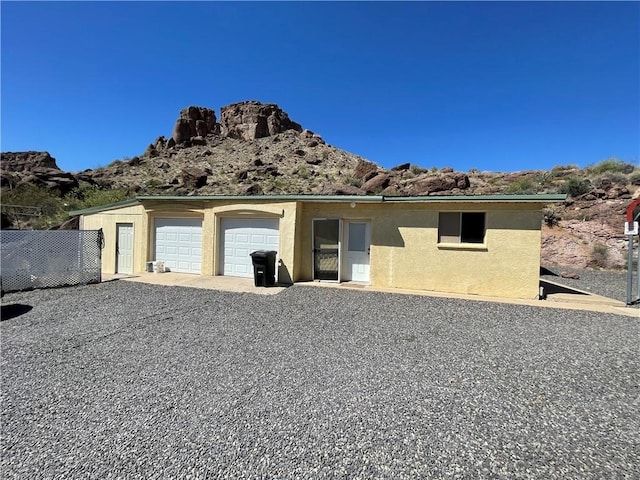 2405 N Clack Canyon Rd, Kingman, AZ 86409 - view of property exterior with a garage, a mountain view, stucco siding, and driveway