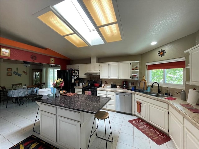 2405 N Clack Canyon Rd, Kingman, AZ 86409 - kitchen featuring black appliances, light tile patterned floors, white cabinets, backsplash, and under cabinet range hood