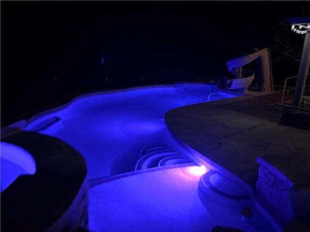 2405 N Clack Canyon Rd, Kingman, AZ 86409 - pool at twilight featuring a water slide, an outdoor pool, and a patio