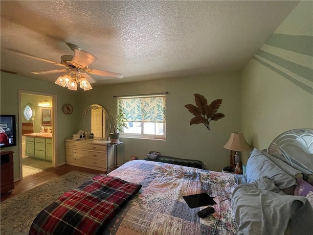 2405 N Clack Canyon Rd, Kingman, AZ 86409 - bedroom with wood finished floors, a textured ceiling, ceiling fan, and ensuite bath