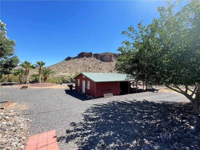2405 N Clack Canyon Rd, Kingman, AZ 86409 - view of home's exterior featuring a mountain view, a metal roof, and an outdoor structure