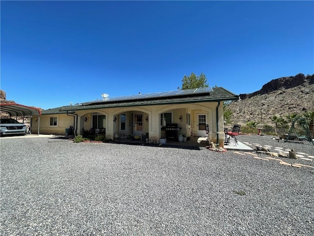 2405 N Clack Canyon Rd, Kingman, AZ 86409 - view of front of home featuring roof mounted solar panels, a carport, and a mountain view