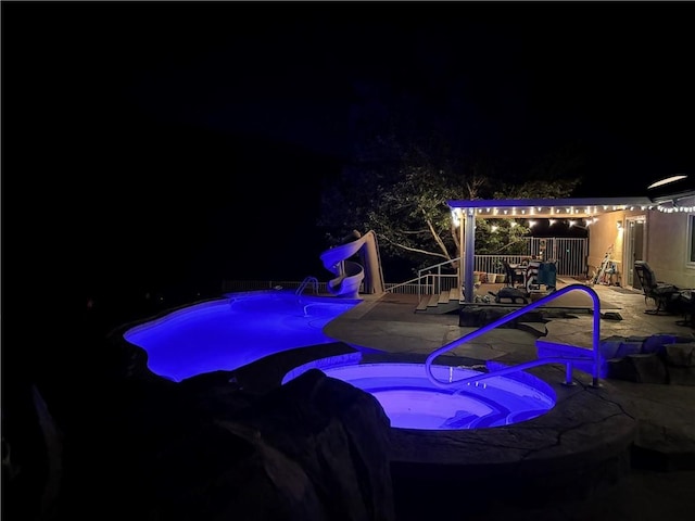 2405 N Clack Canyon Rd, Kingman, AZ 86409 - pool at twilight with a water slide, a patio area, and a pool with connected hot tub