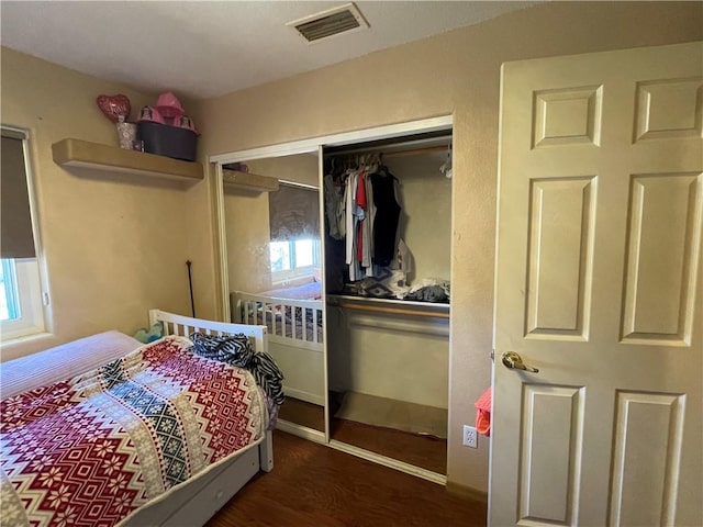 2405 N Clack Canyon Rd, Kingman, AZ 86409 - bedroom featuring wood finished floors, a closet, and multiple windows