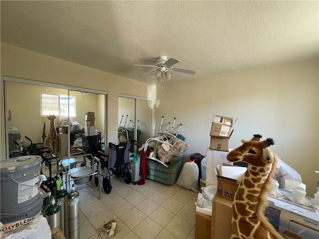 2405 N Clack Canyon Rd, Kingman, AZ 86409 - living area with a ceiling fan, a textured ceiling, and light tile patterned flooring
