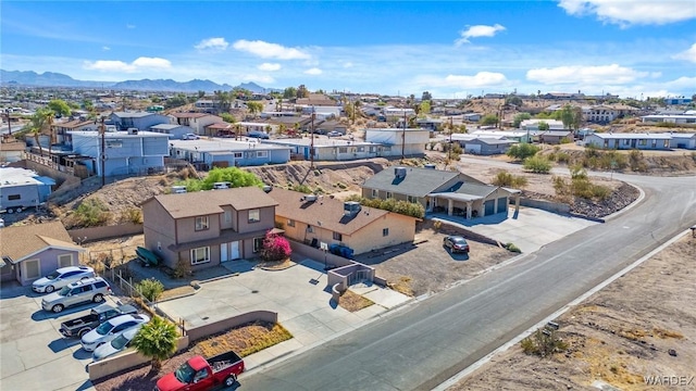 drone / aerial view featuring a residential view and a mountain view