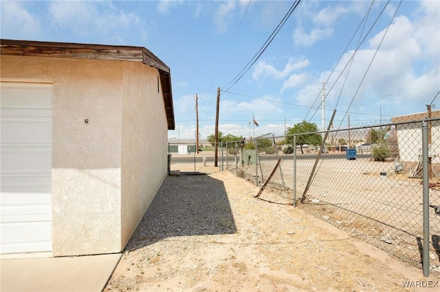 view of yard featuring a garage and fence