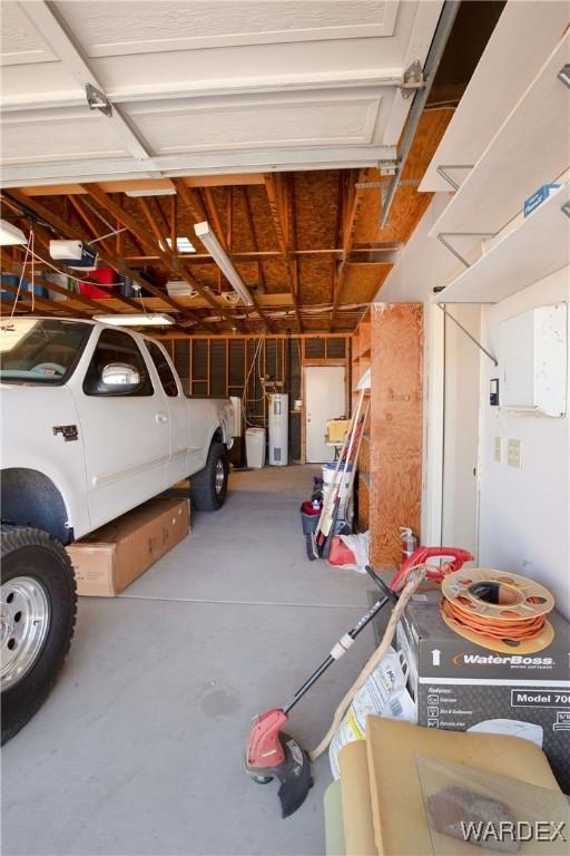 garage with electric water heater and a garage door opener