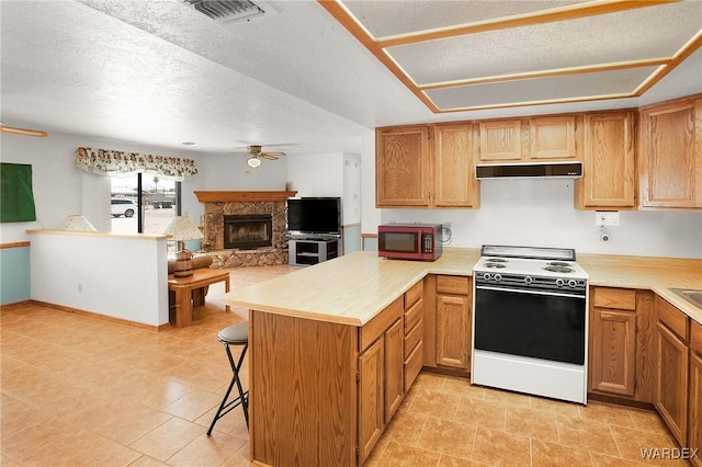 kitchen featuring a peninsula, ceiling fan, light countertops, and white range with electric cooktop