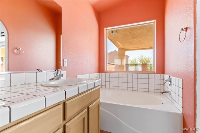 2190 Hijolly Dr, Bullhead City, AZ 86442 - full bathroom with a textured wall, vanity, and a bath