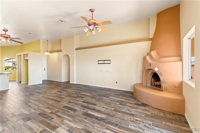 2190 Hijolly Dr, Bullhead City, AZ 86442 - unfurnished living room with baseboards, a ceiling fan, arched walkways, and wood finished floors