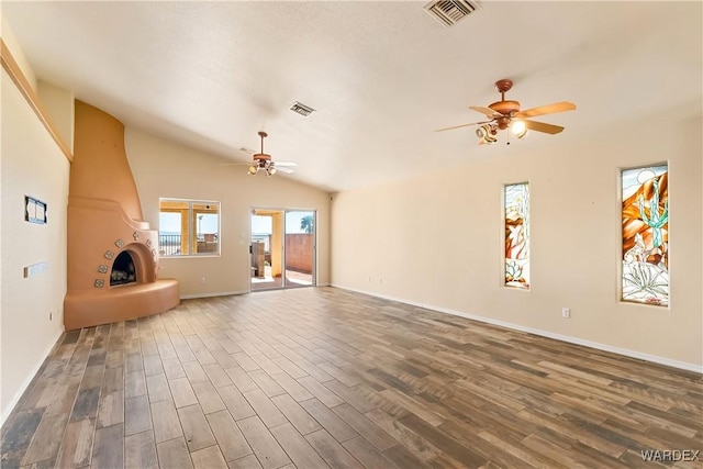 2190 Hijolly Dr, Bullhead City, AZ 86442 - unfurnished living room featuring dark wood finished floors, lofted ceiling, visible vents, and ceiling fan