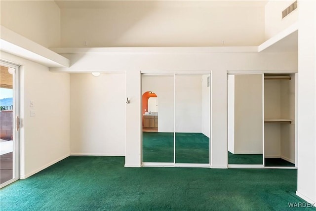 2190 Hijolly Dr, Bullhead City, AZ 86442 - interior space with visible vents, arched walkways, carpet flooring, and two closets
