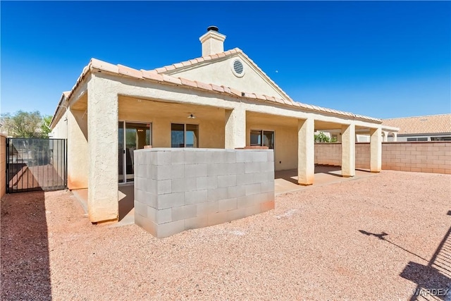 2190 Hijolly Dr, Bullhead City, AZ 86442 - rear view of house with a patio, stucco siding, a chimney, a tile roof, and fence