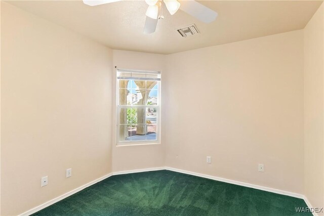2190 Hijolly Dr, Bullhead City, AZ 86442 - empty room with dark carpet, ceiling fan, visible vents, and baseboards