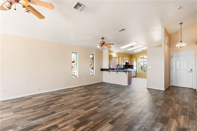 2190 Hijolly Dr, Bullhead City, AZ 86442 - unfurnished living room featuring baseboards, visible vents, dark wood-style flooring, and a ceiling fan