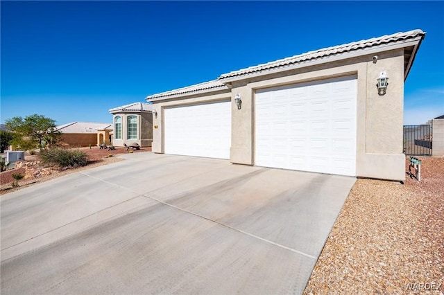 garage featuring concrete driveway