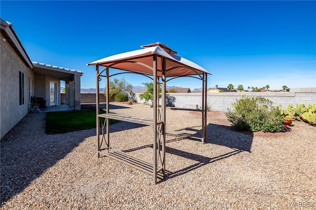 view of play area featuring a fenced backyard and a gazebo