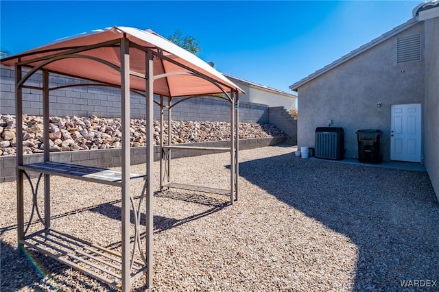 view of yard with a fenced backyard and central AC