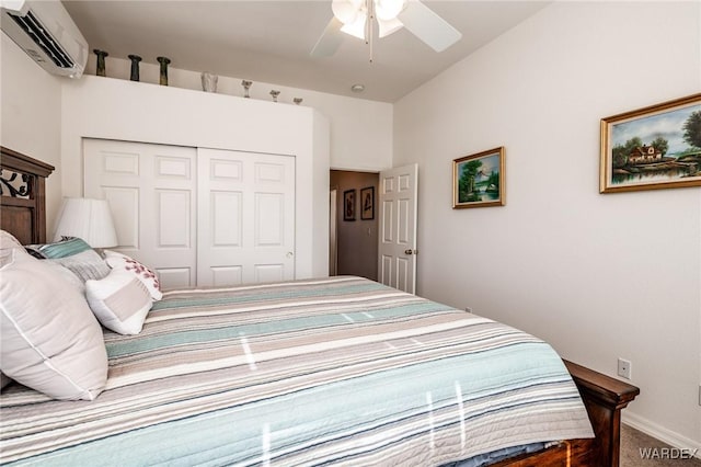 bedroom featuring baseboards, ceiling fan, an AC wall unit, carpet flooring, and a closet