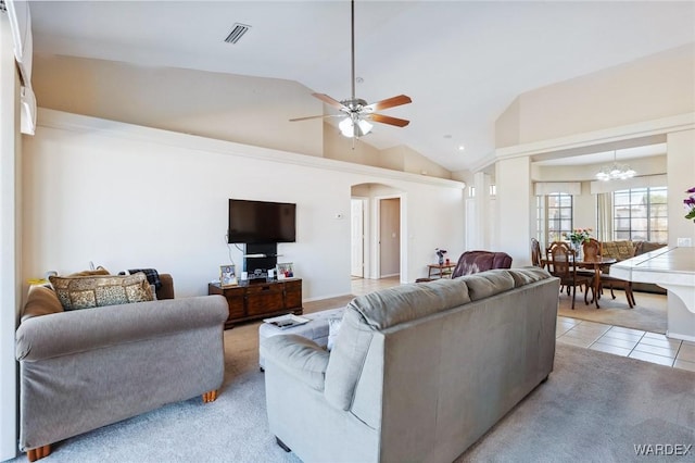 living room featuring arched walkways, light tile patterned floors, visible vents, vaulted ceiling, and ceiling fan with notable chandelier