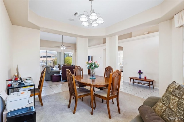 dining room with light tile patterned floors, a tray ceiling, visible vents, and light colored carpet