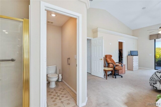 full bath featuring a shower with door, toilet, vaulted ceiling, tile patterned flooring, and baseboards